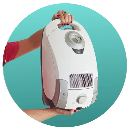 Person holding a white vacuum cleaner