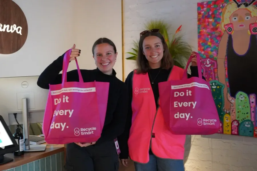 Two Canva staff holding pink ReSmart bags