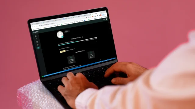 Hands typing on a laptop showing the ReSmart Data Dashboard