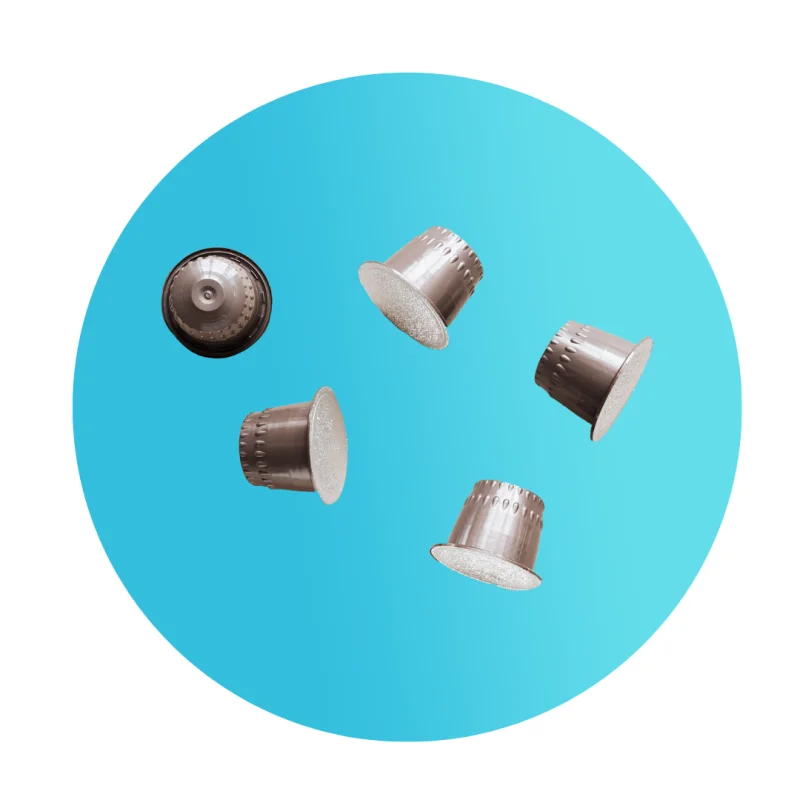 Five used aluminium coffee capsules
